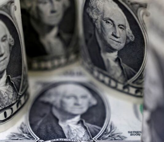 Dollar slips near seven-month lows after jobs data