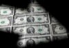 Dollar edges lower; on track for second straight monthly loss