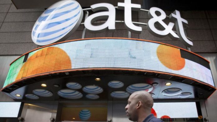 AT&T's equipment writedown hurts annual profit view, shares slip