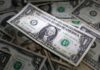 Dollar ticks up as investors gauge rates outlook