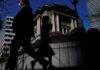 BOJ keeps rates steady, decides to lay out bond taper plan next month