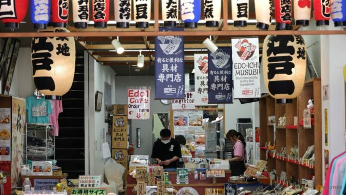 Japan cuts growth forecast, prime minister warns of weak-yen pain