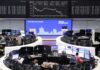 European shares lower on earnings, bonds boosted after Fed