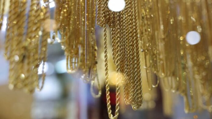 Gold eases after record high on knock-on effect of wider selloff