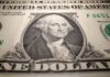 Dollar falls on dovish Fed comments, yen dips after Iran bombings