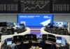 Global stocks near record highs as markets await Trump-Putin talks