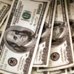 Dollar extends gains on rate cut doubts and safety play; pound slips