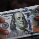 Dollar heads for modest weekly rise, balancing Fed outlook and US data