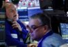 Wall Street lingers around record highs; precious metals rise