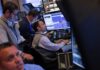 Stocks hit record high, dollar stabilizes ahead of Fed rate call