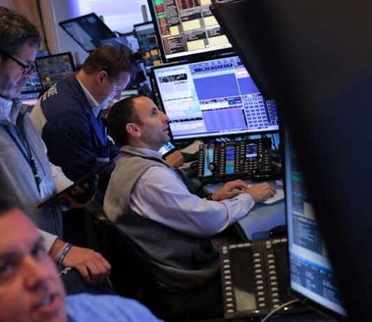 Stocks hit record high, dollar stabilizes ahead of Fed rate call