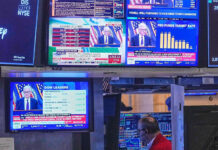 US Fed holds interest rates steady, defying Trump pressure