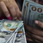 Dollar holds gains on economic data, Fed bets; Aussie advances before RBA