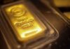 Gold falls on easing geopolitical risks, stronger dollar