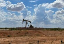 Oil prices down $2 a barrel on supply forecast