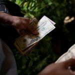Dollar scarcity in Venezuela forces small firms to raise prices, turn to crypto