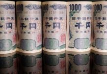 S&P affirms Japan debt rating but warns of cut if yen weakens much further