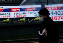 Stocks slide in Asia, Brent crude heads for record monthly rise