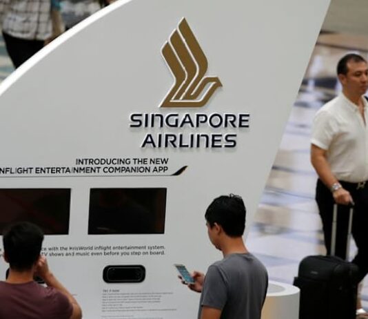Singapore Airlines flags surging fuel costs; annual profit halves on one-offs