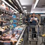 US revises first quarter growth down while inflation climbs