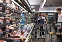 US revises first quarter growth down while inflation climbs
