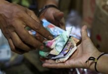 Indonesian central bank says governor briefs foreign investors following surprise rate hike