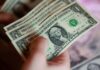 Dollar slips after touching one-week high as Iran deal in question