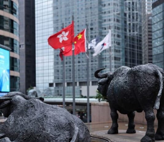 Shares edge higher in Asia as oil dips, earnings loom