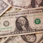 Dollar higher after Iran sanctions, loonie drops after US announces tariff increases