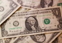 Dollar higher after Iran sanctions, loonie drops after US announces tariff increases