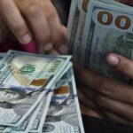 Dollar holds near two-month peak as yields rise, Fed data looms
