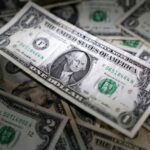 Dollar hovers near 2-month peak, Swiss Franc falls, Norwegian crown rises
