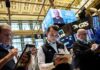 Nasdaq sets record high on AI optimism, oil drops below $100
