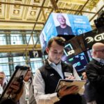 Nasdaq sets record high on AI optimism, oil drops below $100
