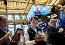 Nasdaq sets record high on AI optimism, oil drops below $100